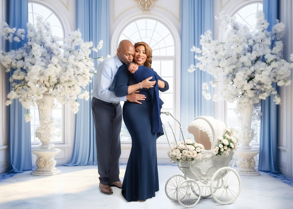 Family portrait with newborn in soft blue digital background featuring floral decor and white pram, Birmingham newborn studio.