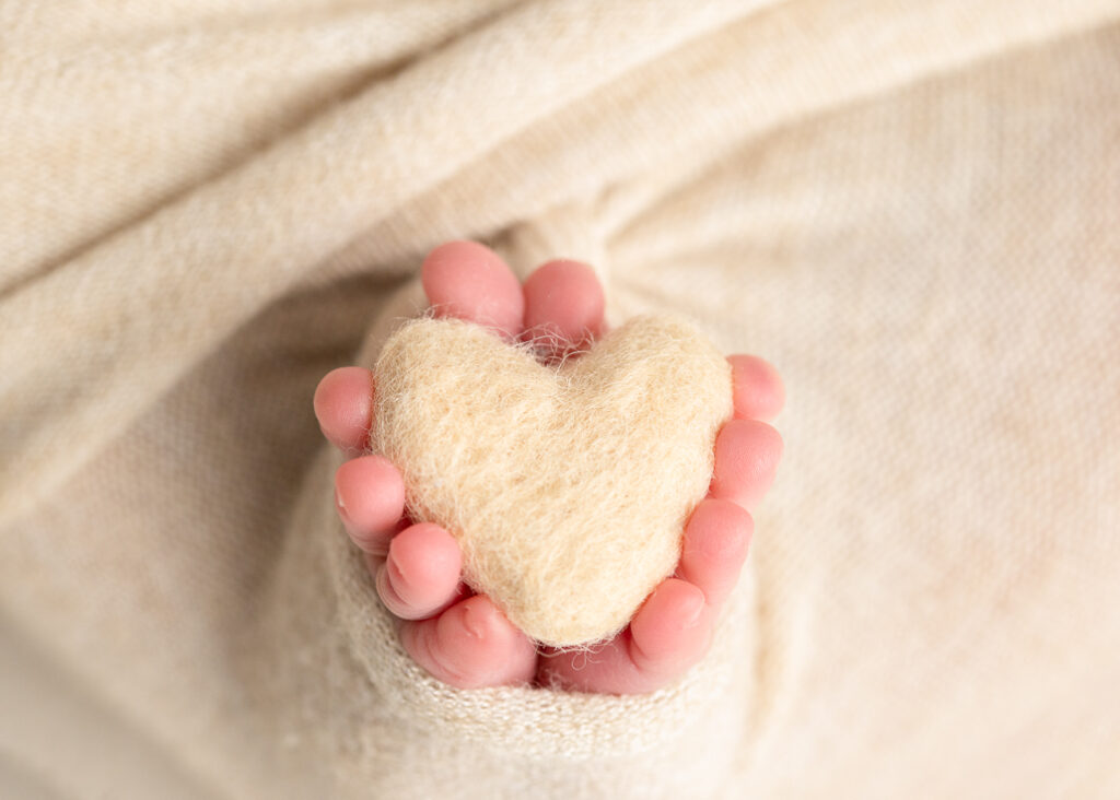 Close-up detail of newborn baby’s tiny toes, showing the delicate and intricate features of a newborn