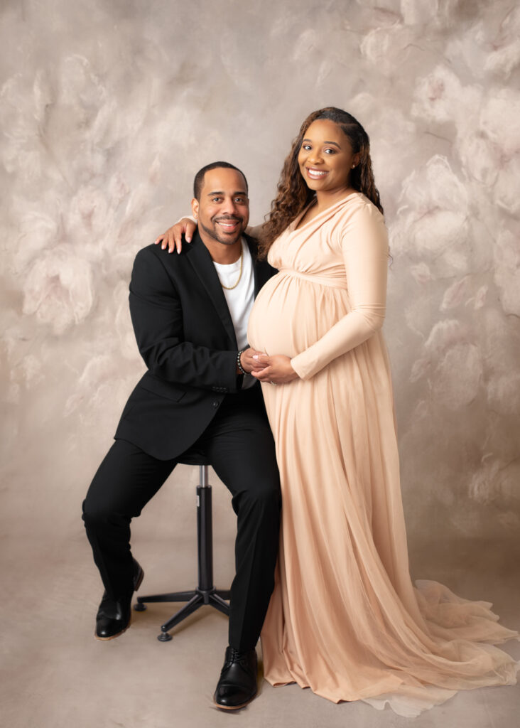 Studio maternity portrait of a couple posing with soft lighting in Birmingham, AL