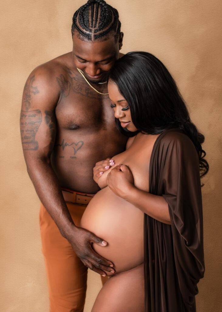 Studio maternity portrait of a couple posing with soft lighting in Birmingham, AL