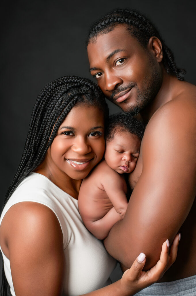 maternity and newborn portraits of a new mom and dad with their newborn baby.