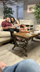 Family reviewing album swatches and artwork options during a design consult in the home studio