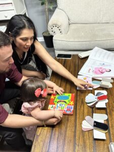 Family reviewing album swatches and artwork options during a design consult in the home studio