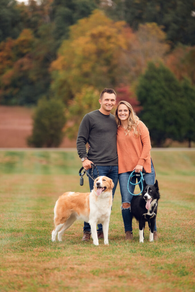 Fall family photo outfits Birmingham with parents, kids, and dog in coordinated fall wardrobe.