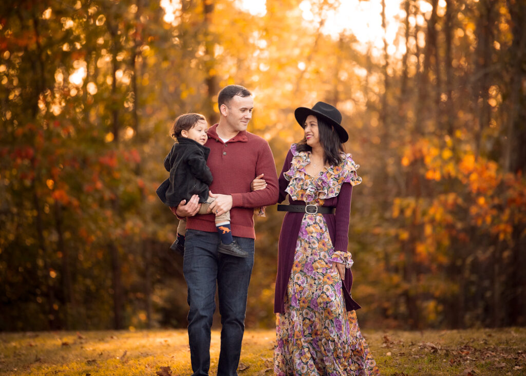 Parents in boho tones carrying toddler