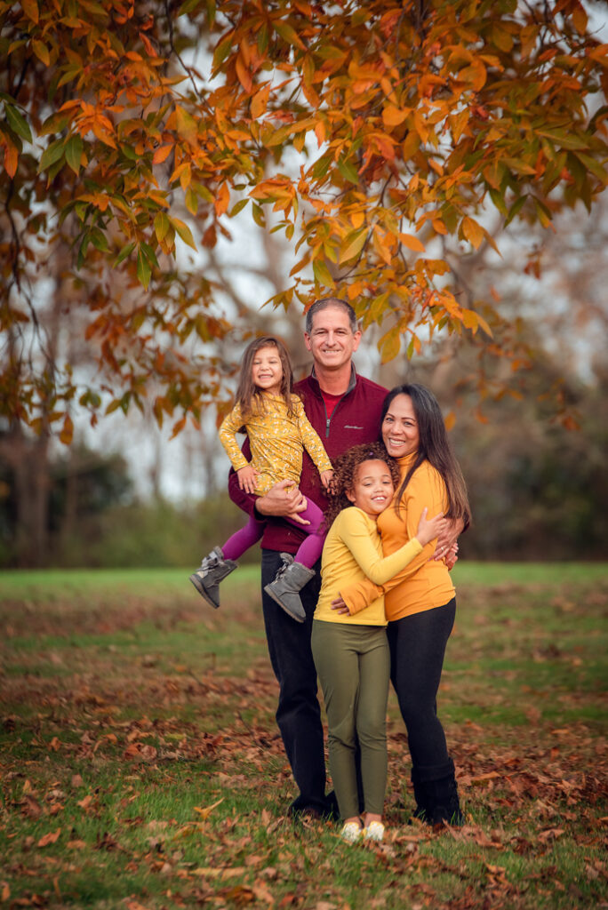 Fall family photo outfits Birmingham with extended family wearing mustard and cream.