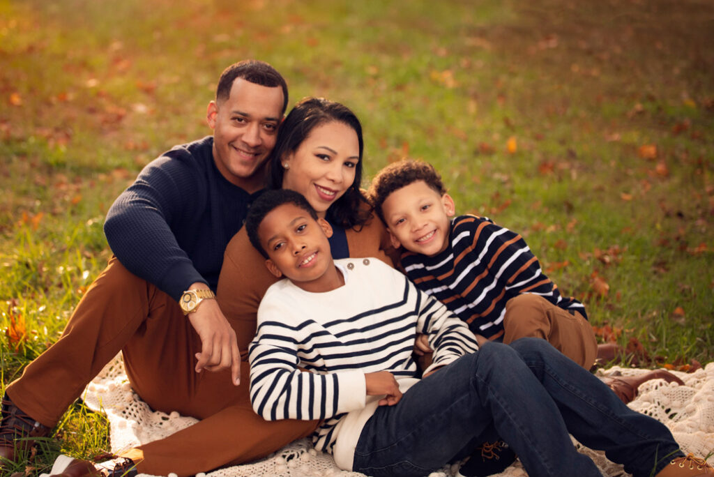 Parents and children cuddled in stripes and neutrals.