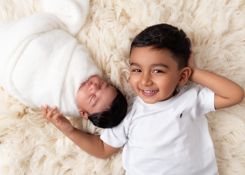 Heirloom sibling portrait in white and cream tones, captured by a luxury family photographer in Birmingham, AL.