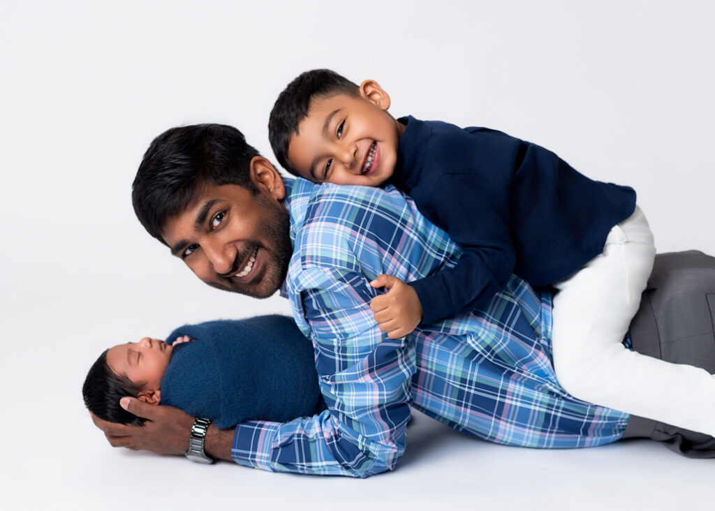 Intimate family portrait showing the connection between dad and siblings, styled for timeless, high-end wall art
