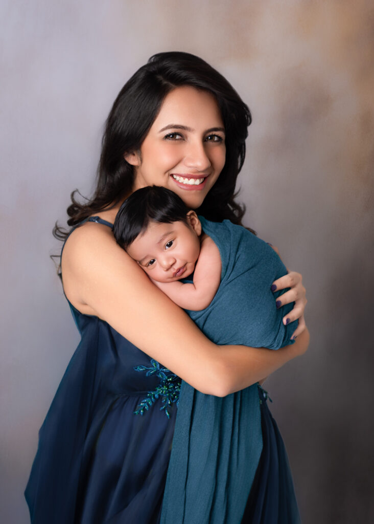 Soft, elegant newborn portrait of mother and baby, showing the flawless posing and lighting of a Birmingham studio session.